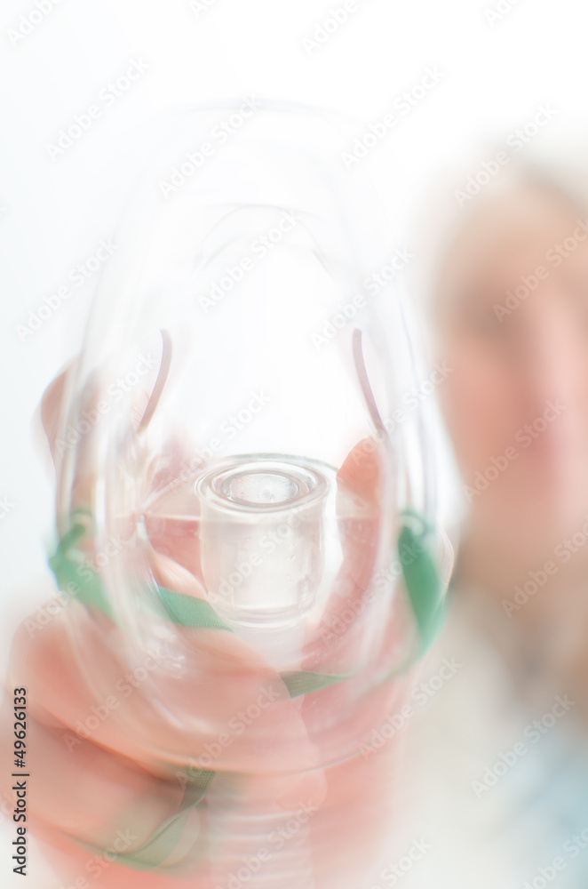 Female assisitant giving gas mask to patient Female assisitant giving gas mask to patient