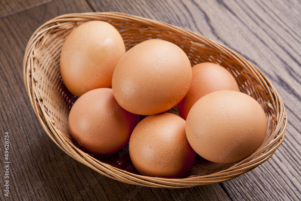 eggs in a bascket on wooden table eggs in a bascket on wooden table