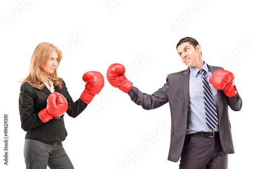 Businesswoman with boxing gloves having a fight with a businessm photo