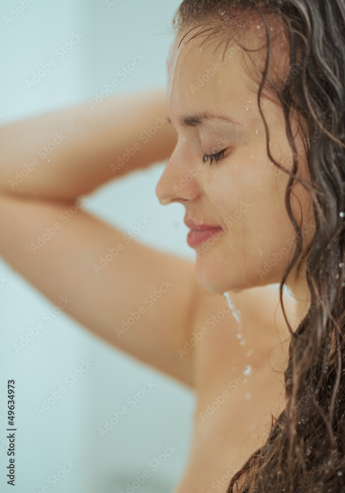 Young woman washing in bathroom Young woman washing in bathroom