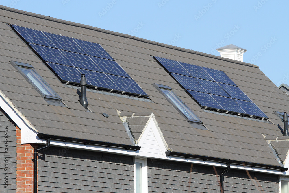 Solar photovoltaic panel arrays on house roof Solar photovoltaic panel arrays on house roof