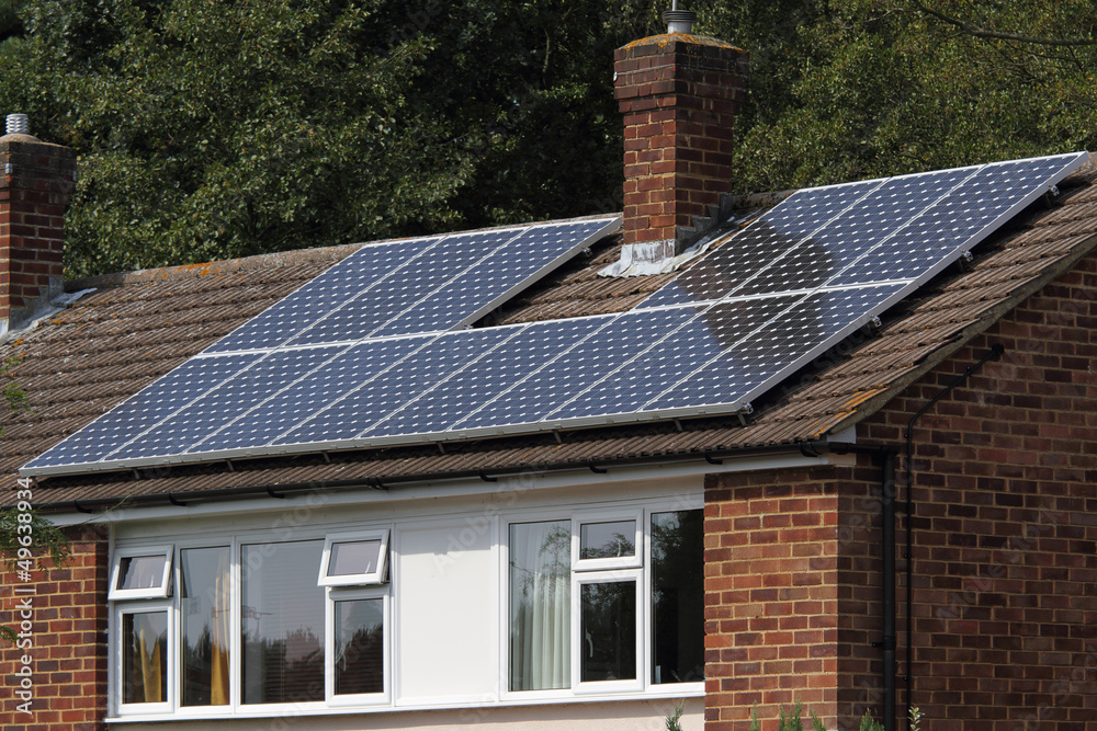 Fototapeta premium Solar photovoltaic panel array on house roof
