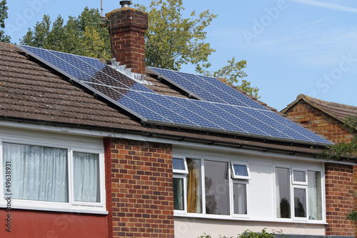 Solar photovoltaic panel array on house roof
