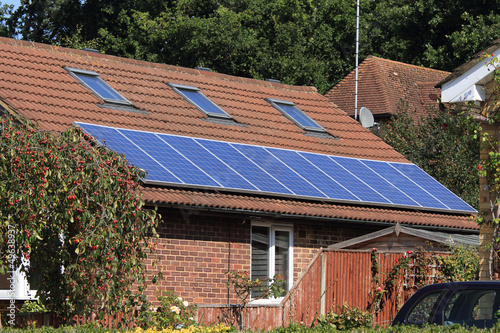 Solar photovoltaic panel array on house roof