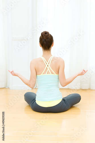 Beautiful young woman doing yoga exercise