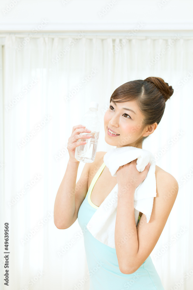 Beautiful young woman drinking water at workout Beautiful young woman drinking water at workout