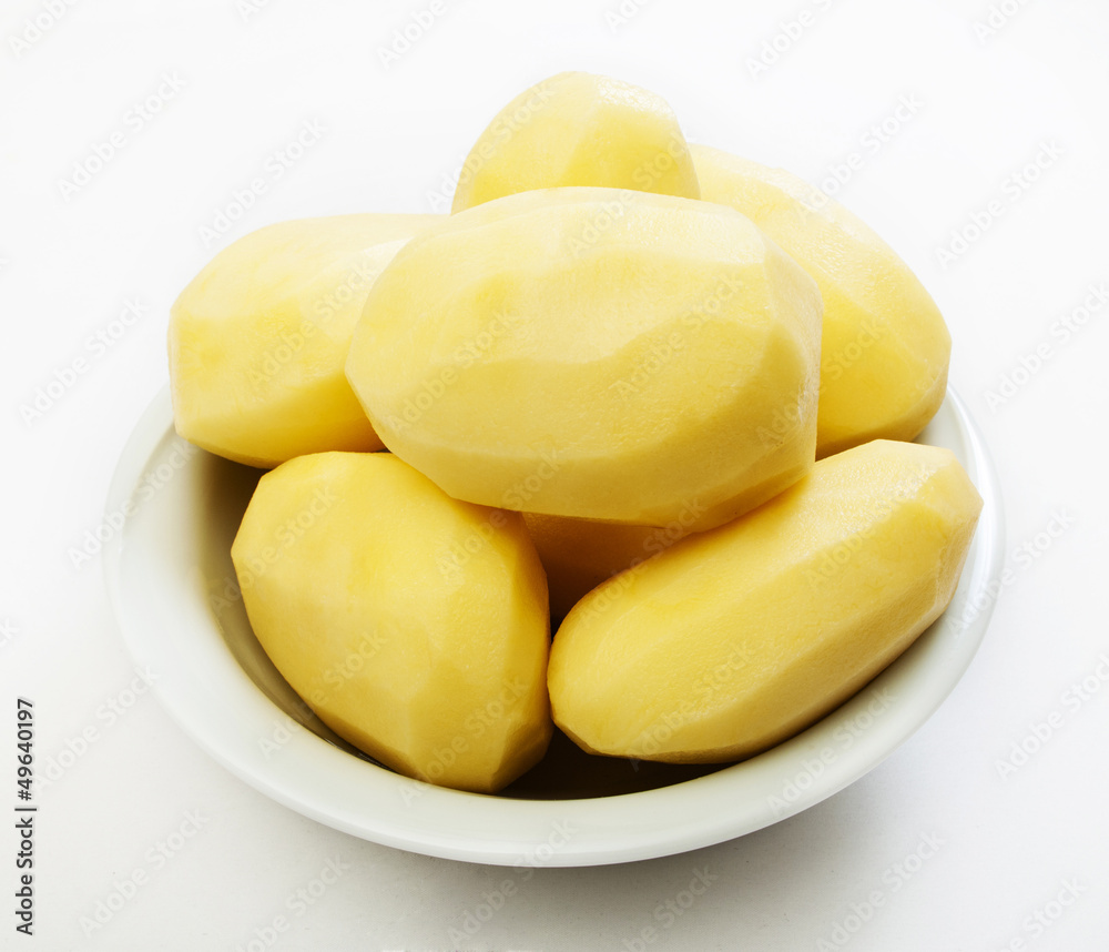 Raw peeled potatoes isolated on a white background Raw peeled potatoes isolated on a white background