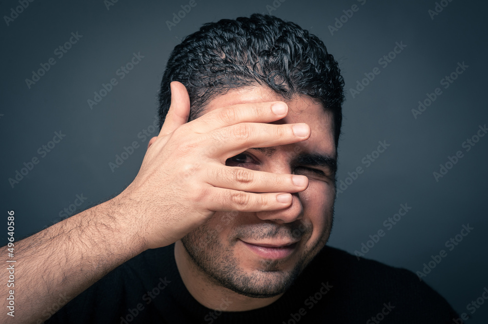 Fototapeta premium Man joking close up portrait against dark background.