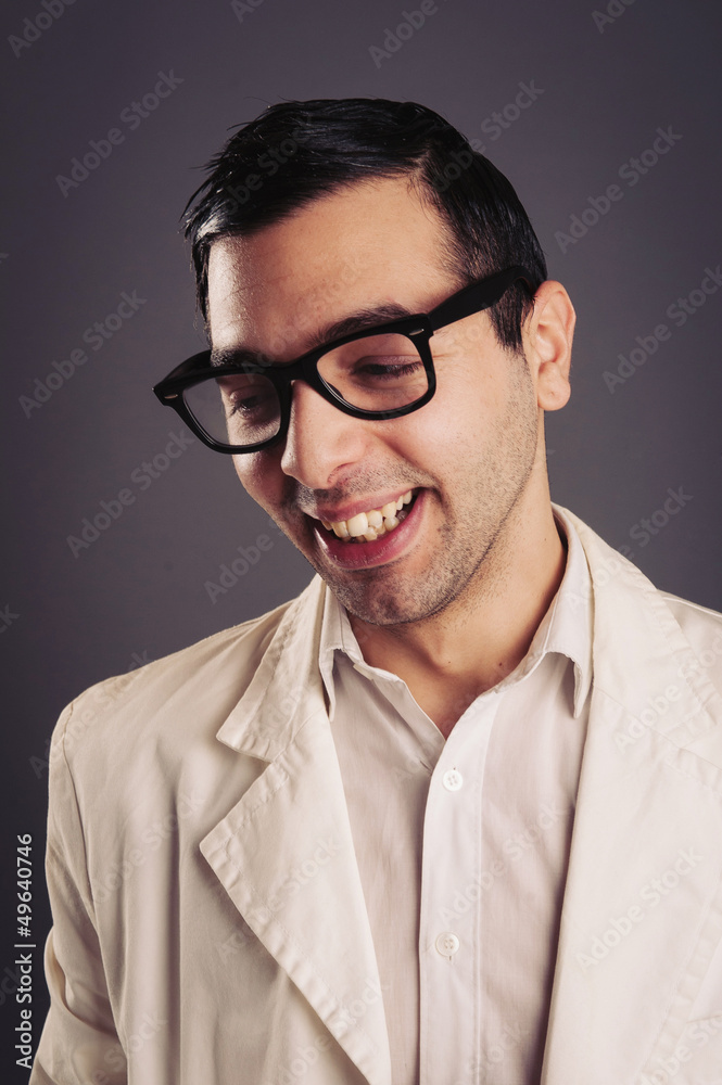 Funny portrait of young nerd with eyeglasses on grey background. Funny portrait of young nerd with eyeglasses on grey background.