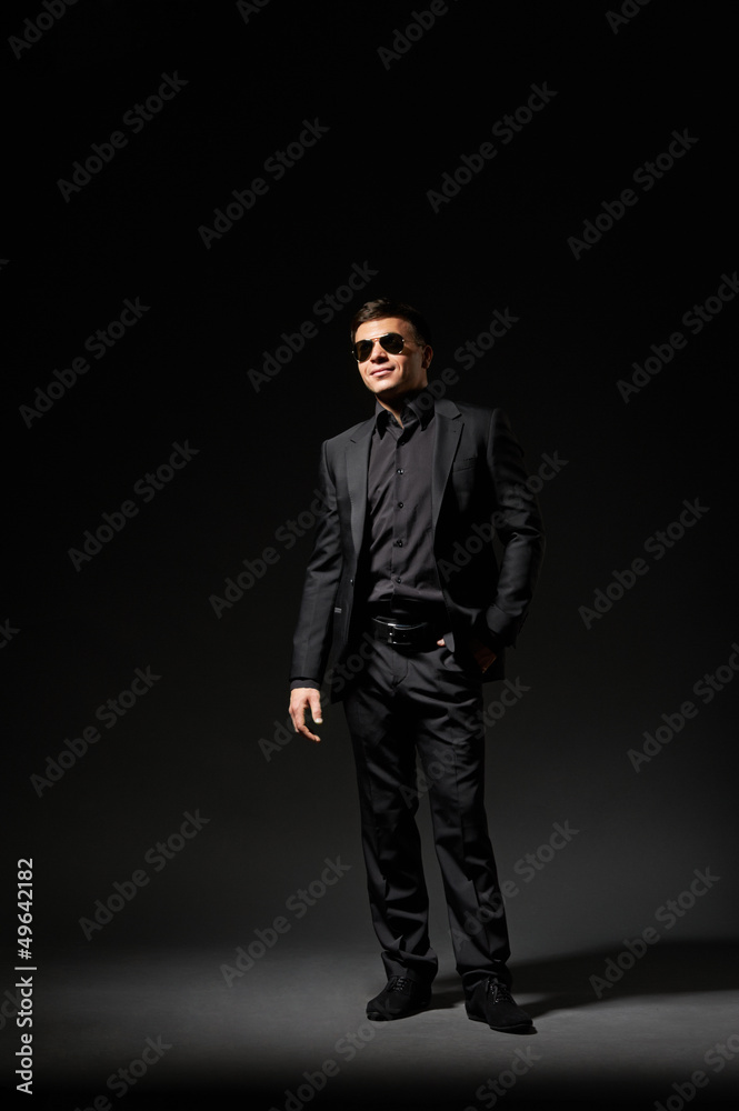young man in black suit and sunglasses