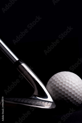 golf club with ball on black background