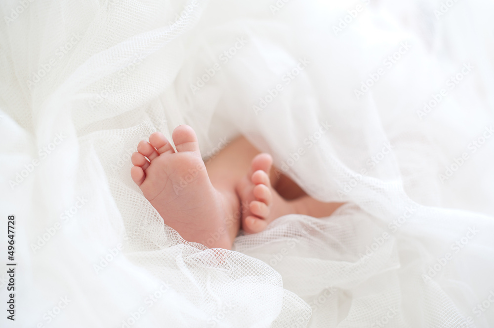 Baby feet in a white diaper Baby feet in a white diaper