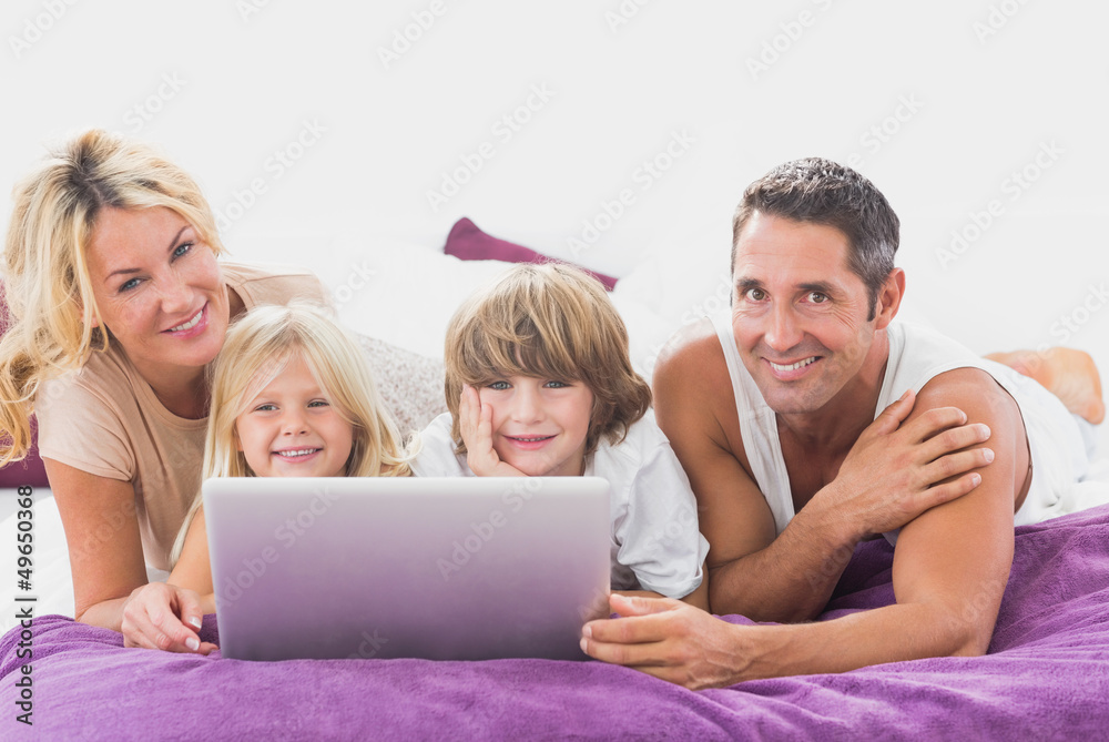 Smiling family using laptop Smiling family using laptop