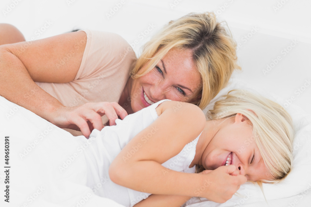 Mother tickling her daughter Mother tickling her daughter