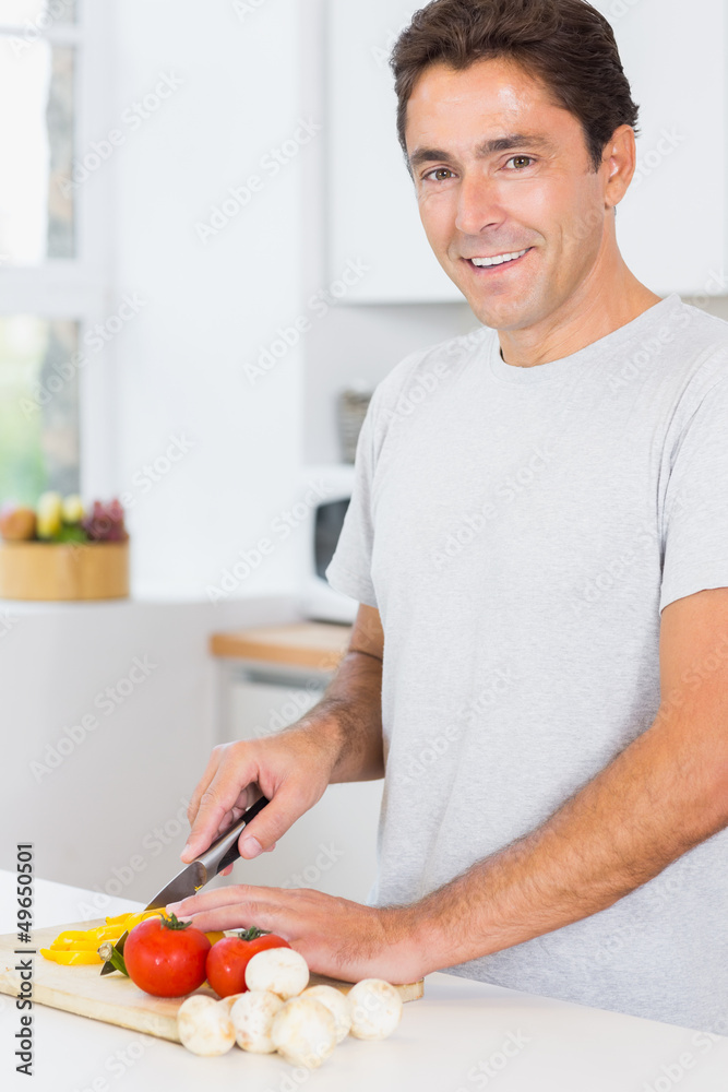 Smiling man preparing vegetables Smiling man preparing vegetables