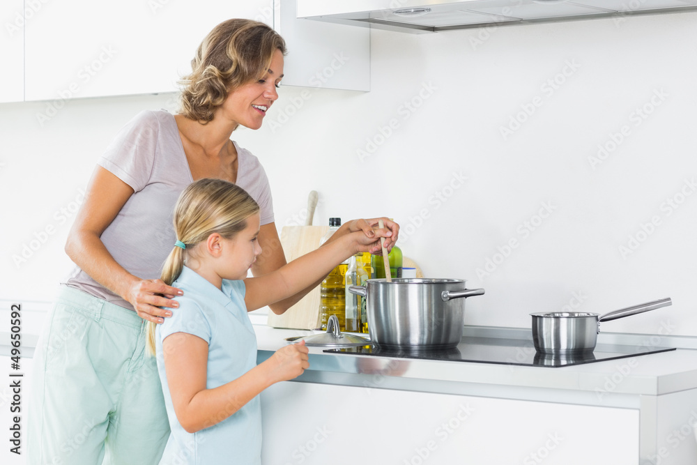 Mother and daughter preparing dinner