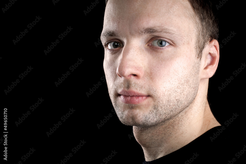 Obraz premium Portrait of young Caucasian man isolated on black background
