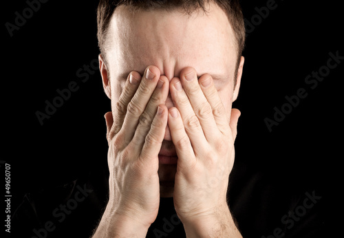 Portrait of stressed man covers face with hands
