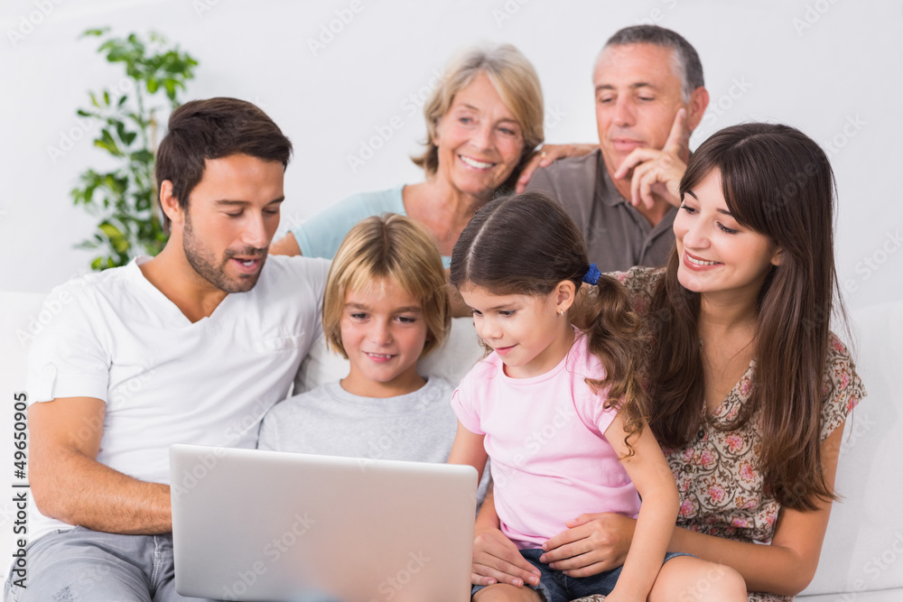 Happy family looking at laptop
