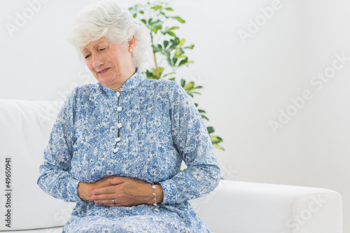 Elderly woman having a belly pain