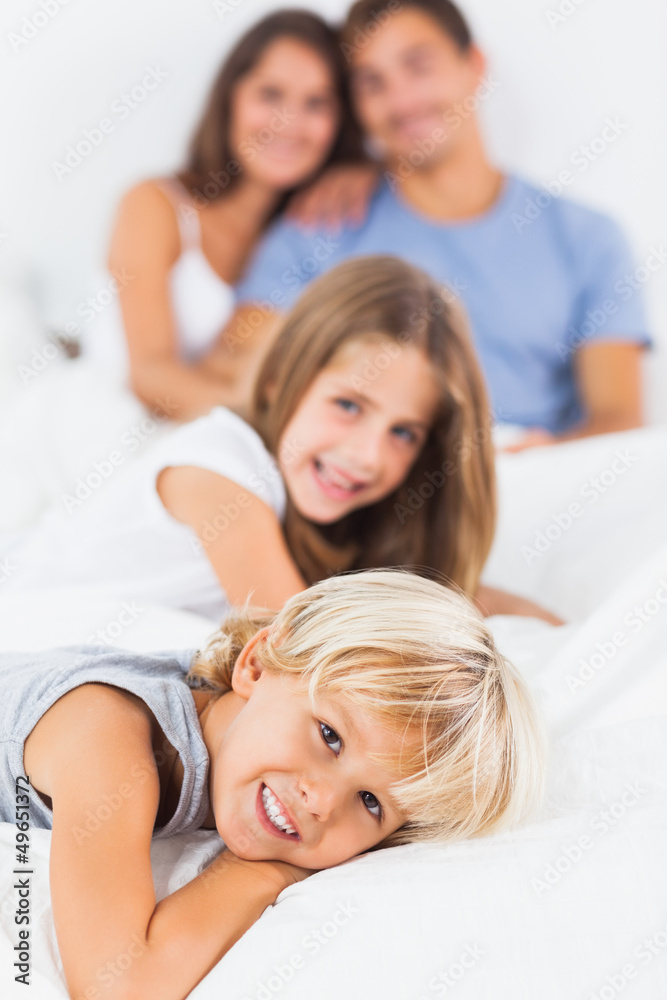 Smiling children lying on the bed Smiling children lying on the bed