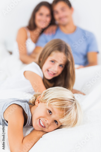 Smiling children lying on the bed