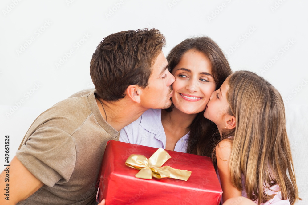 Father and his daughter offering a red gift Father and his daughter offering a red gift