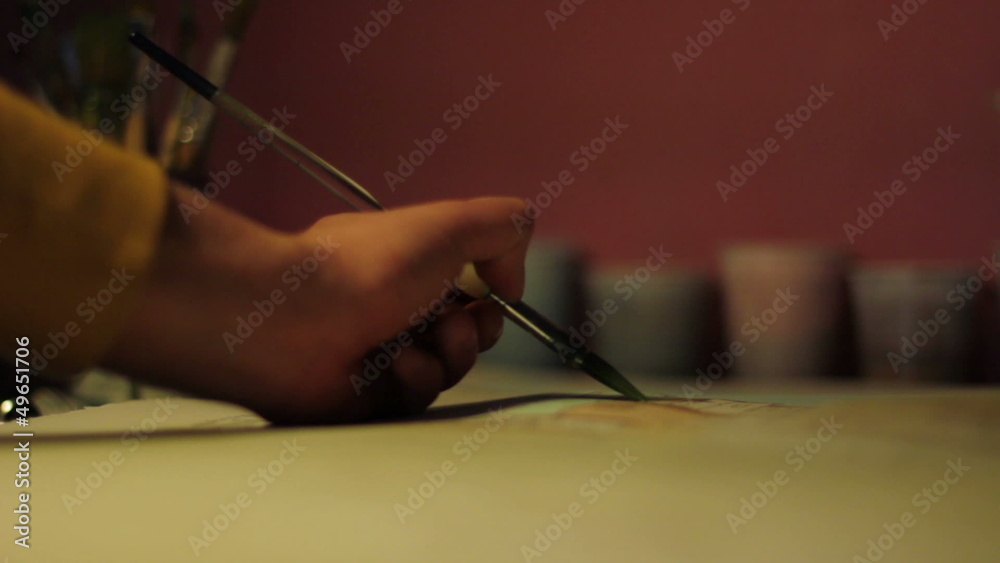 Watercolor painter - hand that paints a landscape