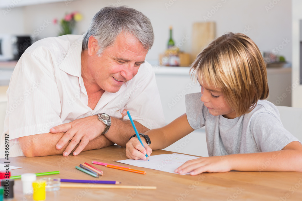 Grandfather looking at the drawing of his grandson Grandfather looking at the drawing of his grandson