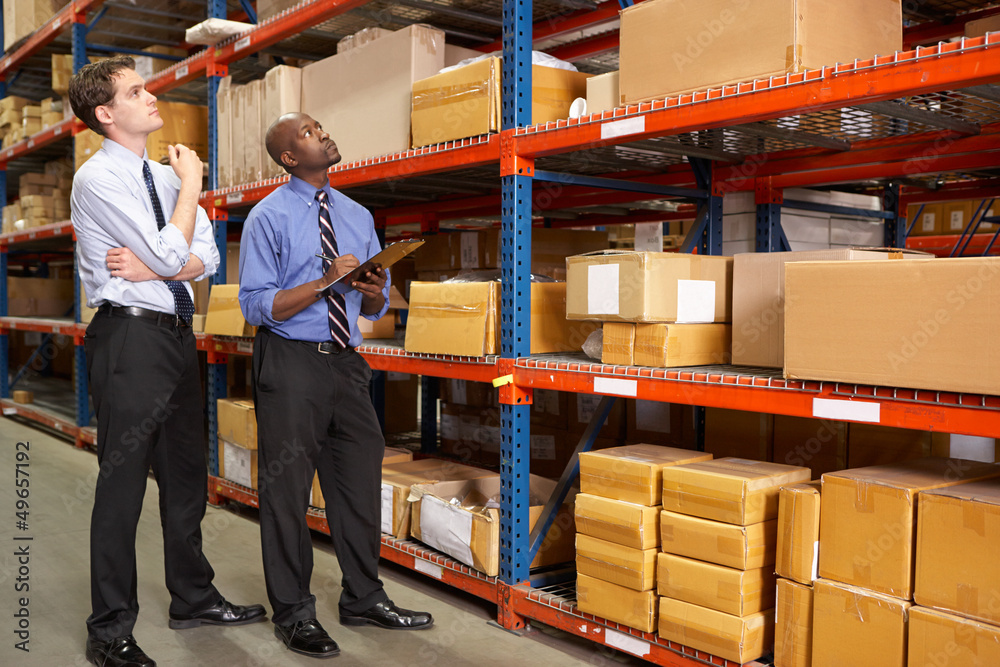 Two Businessmen With Clipboard In Warehouse
