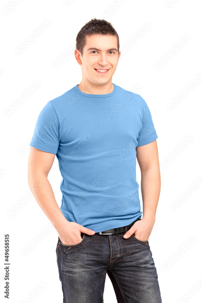 Smiling young man posing with hands in pockets Smiling young man posing with hands in pockets