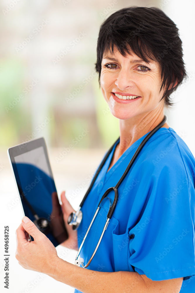 pretty middle aged medical doctor with tablet computer in office pretty middle aged medical doctor with tablet computer in office
