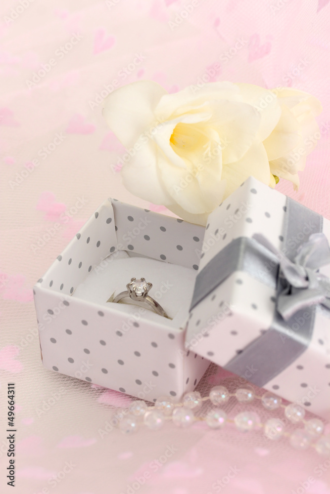 Beautiful box with wedding ring and flower on pink background Beautiful box with wedding ring and flower on pink background