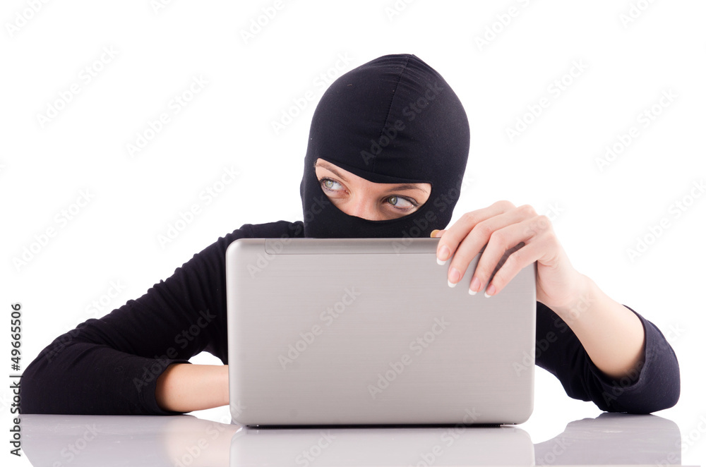 Hacker with computer wearing balaclava Hacker with computer wearing balaclava