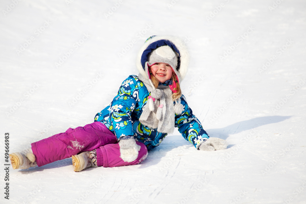 Winter activity: little child having fun in the snow Winter activity: little child having fun in the snow