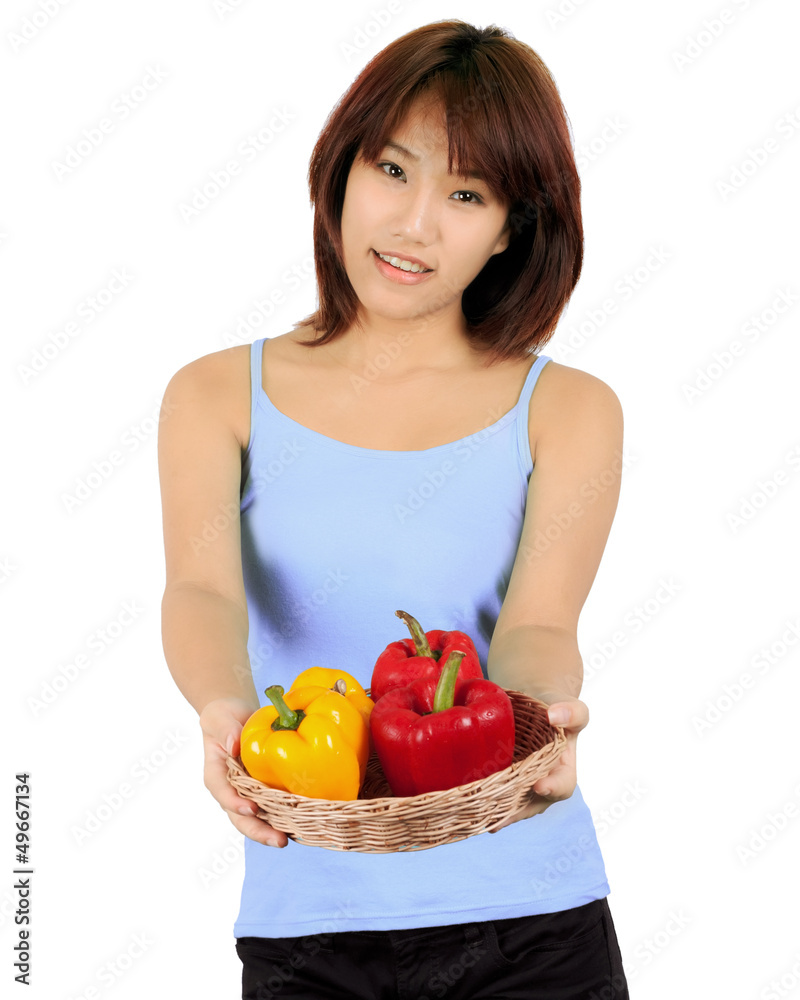 Isolated young asian woman with paprika on white Isolated young asian woman with paprika on white