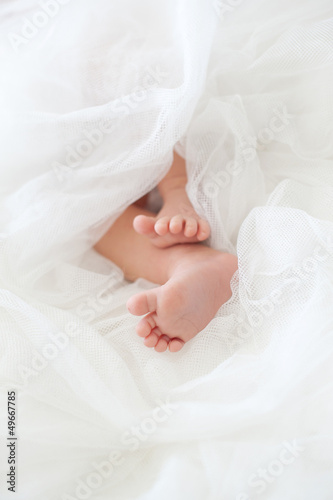 Baby feet in a white diaper