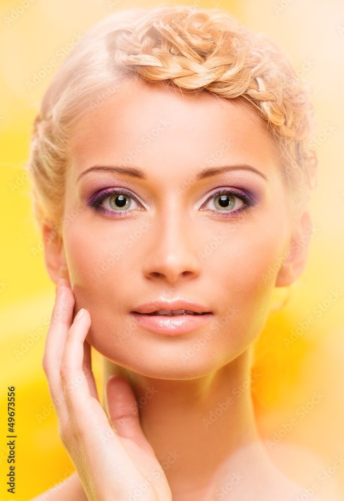 Beautiful young woman with hairdo touching her face with hand Beautiful young woman with hairdo touching her face with hand