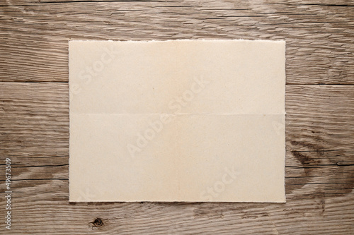 Old paper on wooden background