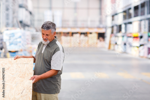Senior man buying construction wood in a DIY store