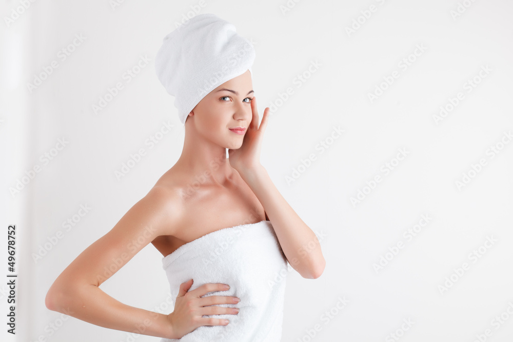 Beautiful blonde female model in bath towel on white background Beautiful blonde female model in bath towel on white background