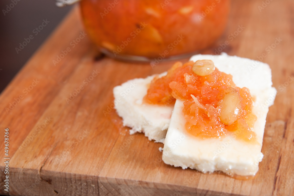 Sweet quince jam with almonds on white cheese Sweet quince jam with almonds on white cheese