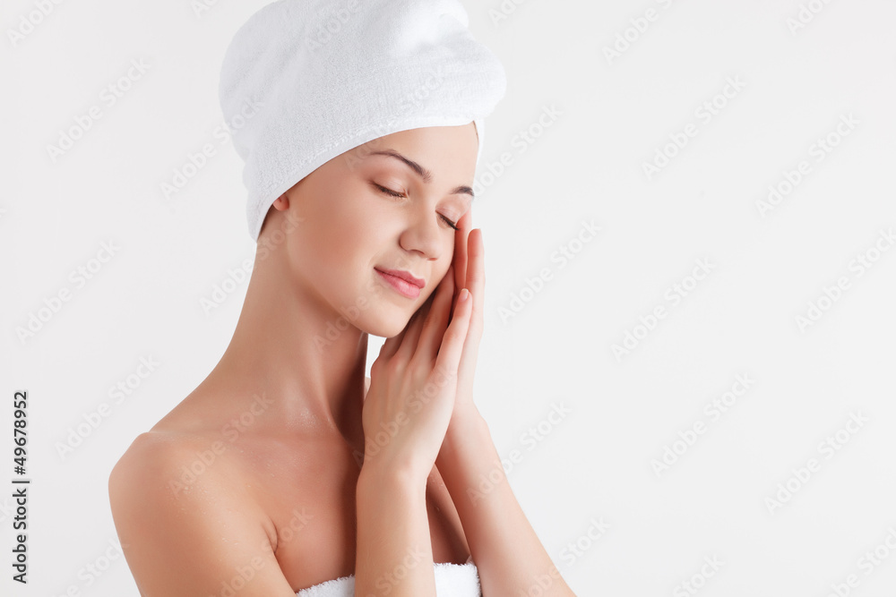 Beautiful blonde female model in bath towel on white background Beautiful blonde female model in bath towel on white background