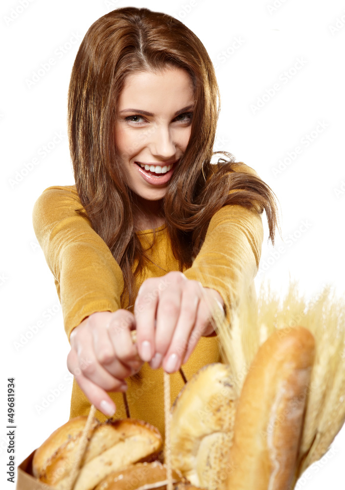 Portrait of smiling young woman holding a shopping bag full of g Portrait of smiling young woman holding a shopping bag full of g