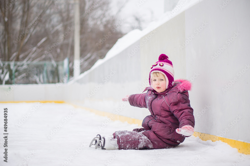 Adorable girl skate on ice rink, seat on ice after fall Adorable girl skate on ice rink, seat on ice after fall