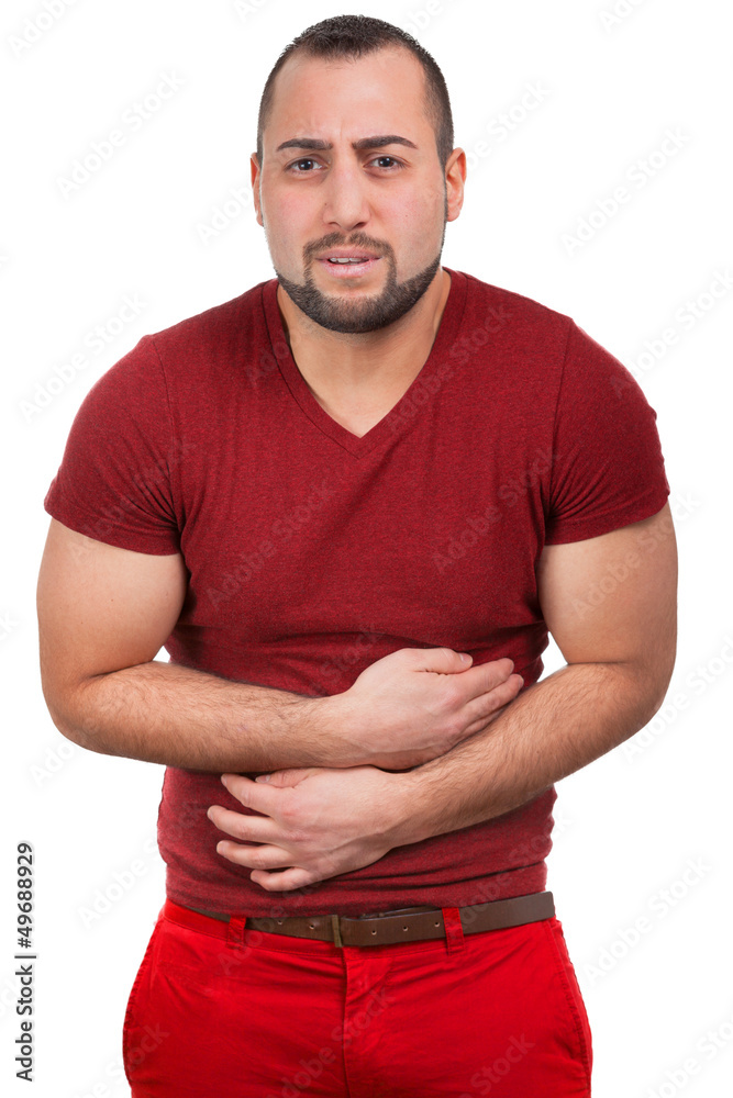 Fototapeta premium Mann mit starken Schmerzen im Bauch krümmt sich