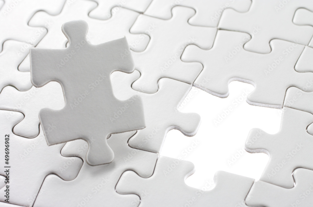 Unfinished jigsaw puzzle and last piece. Unfinished jigsaw puzzle and last piece.