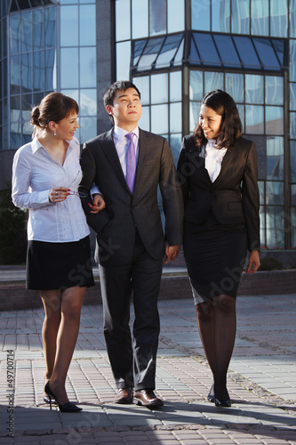 Business people walking and talking in the street
