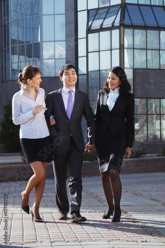 Business people walking and talking in the street.