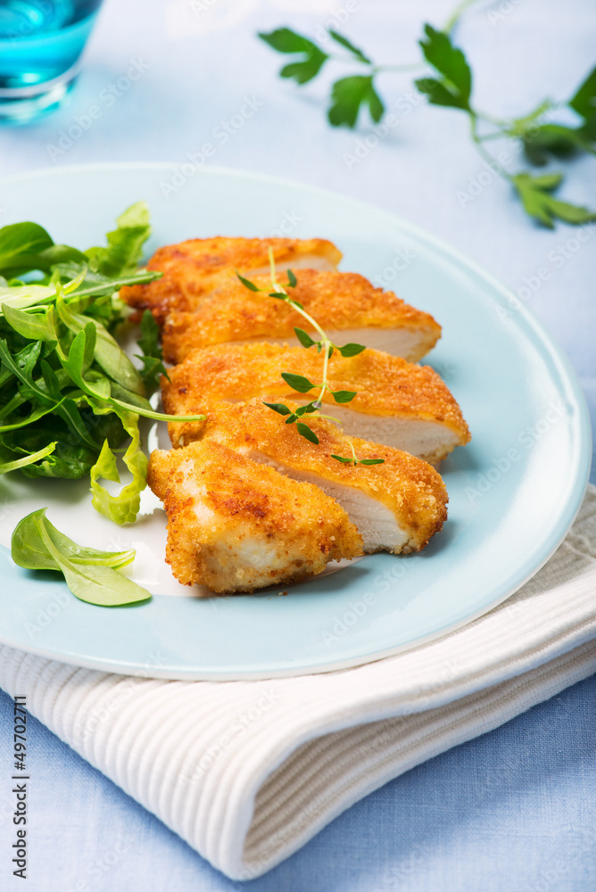 fried, breaded chicken fillet with fresh salad fried, breaded chicken fillet with fresh salad